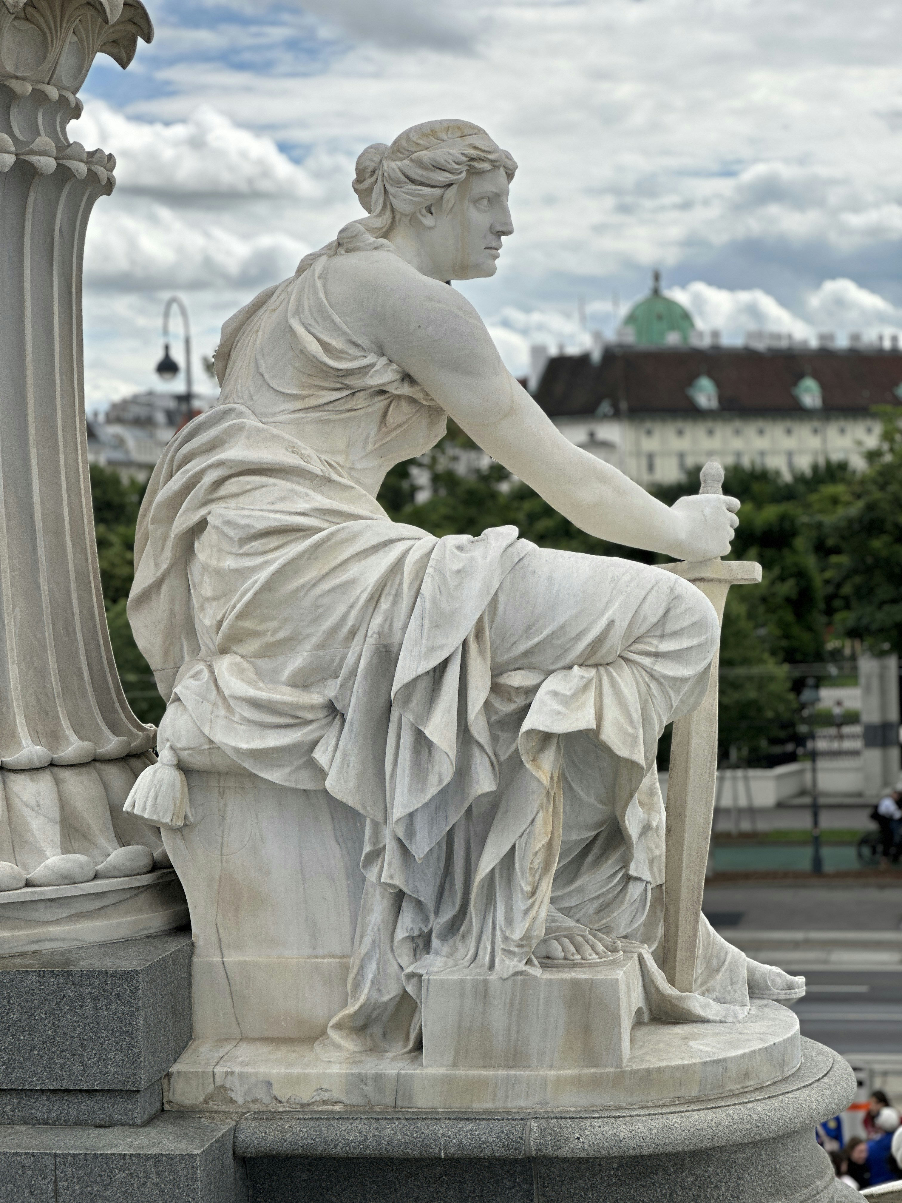 A statue of a woman sitting on a pedestal
