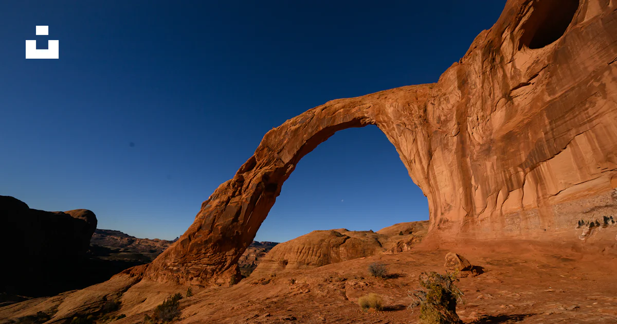 An Arch That Rocks A rock arch in the middle of a desert photo – Free Corona arch Image on ...