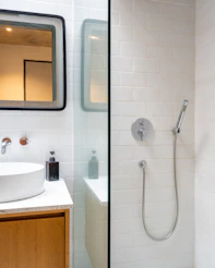 A bathroom with a sink and a shower