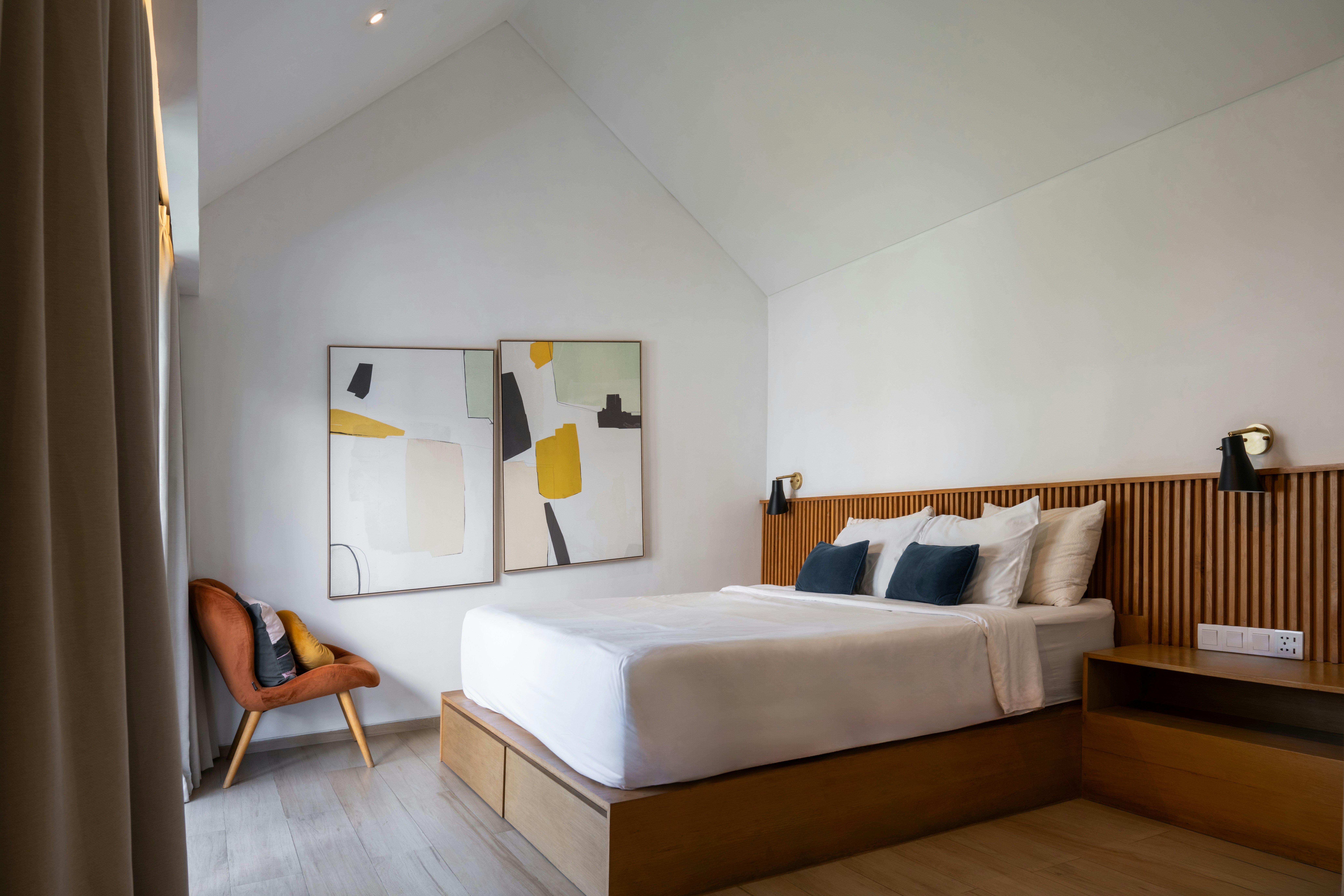 A bedroom with a bed and a chair in it