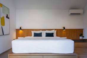 A bedroom with a bed and a painting on the wall