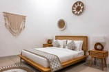 A bed room with a neatly made bed and a table