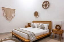 A bed room with a neatly made bed and a table