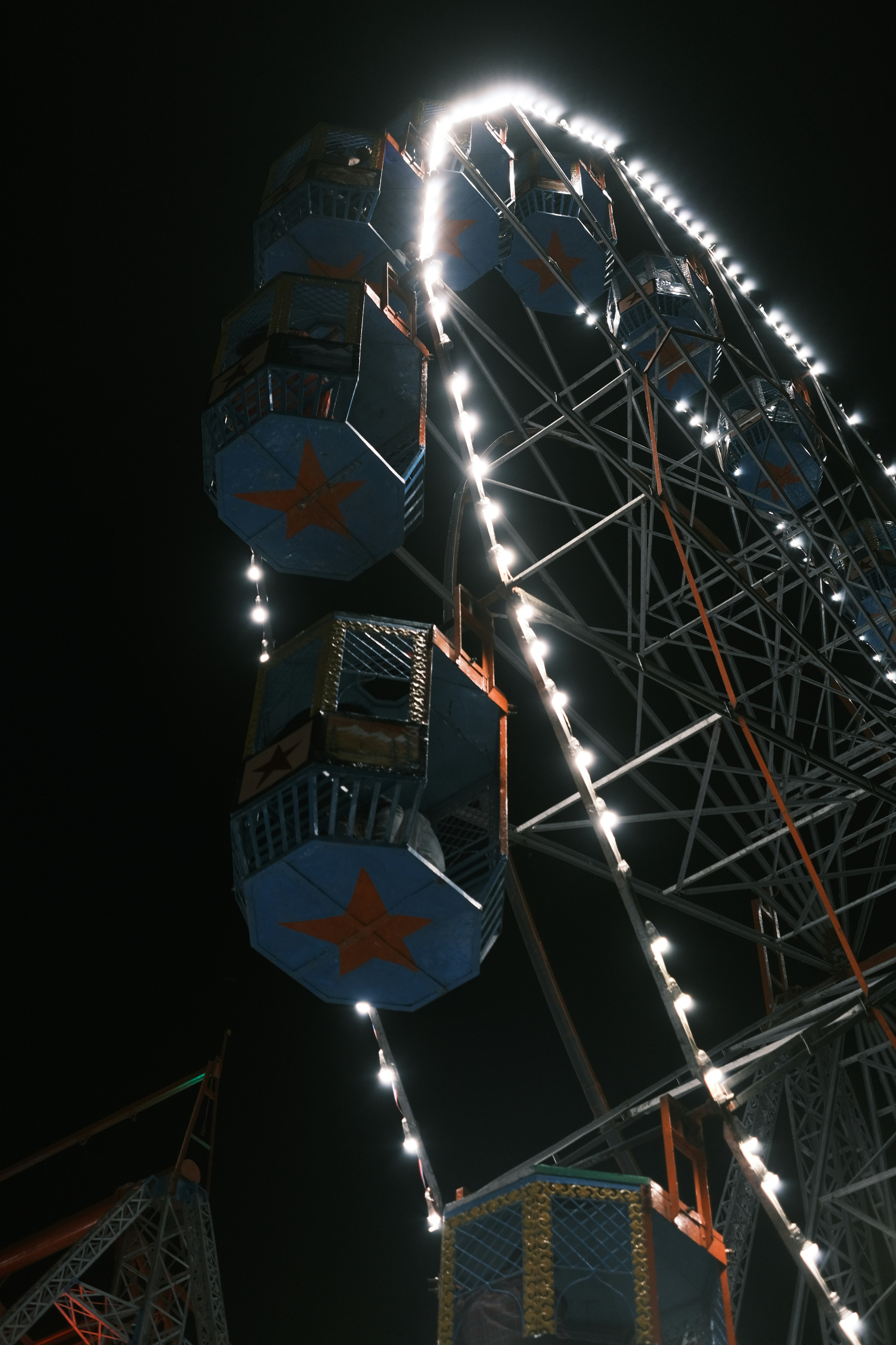 A large ferris wheel lit up at night