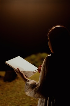 A woman holding a book in her hands