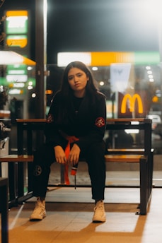 A woman sitting on a bench in a restaurant
