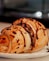 A pastry with chocolate drizzled on top of it