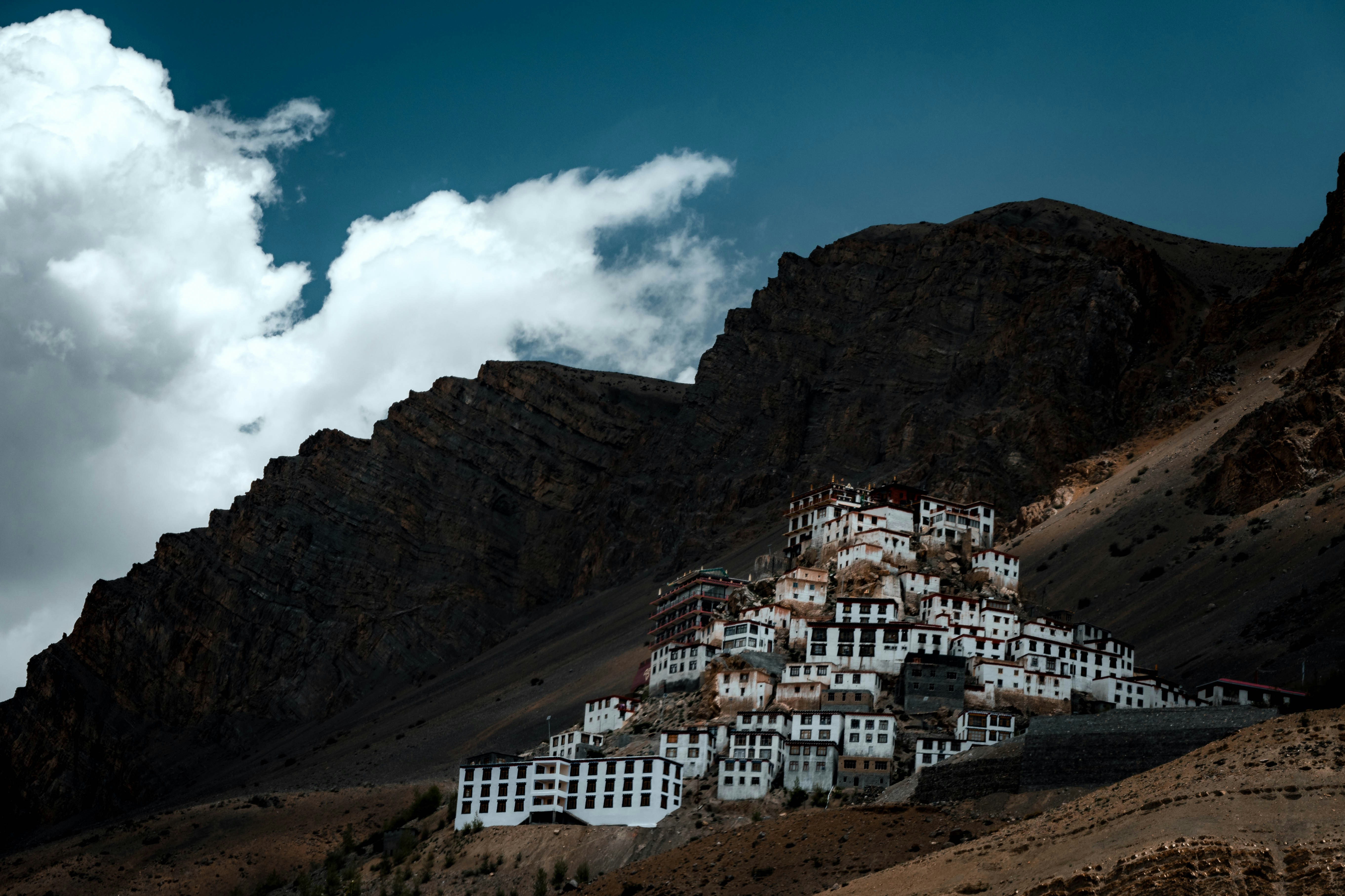 A mountain with a bunch of white buildings on top of it