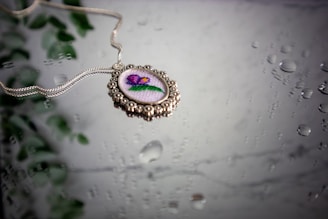 A necklace with a picture of a flower on it