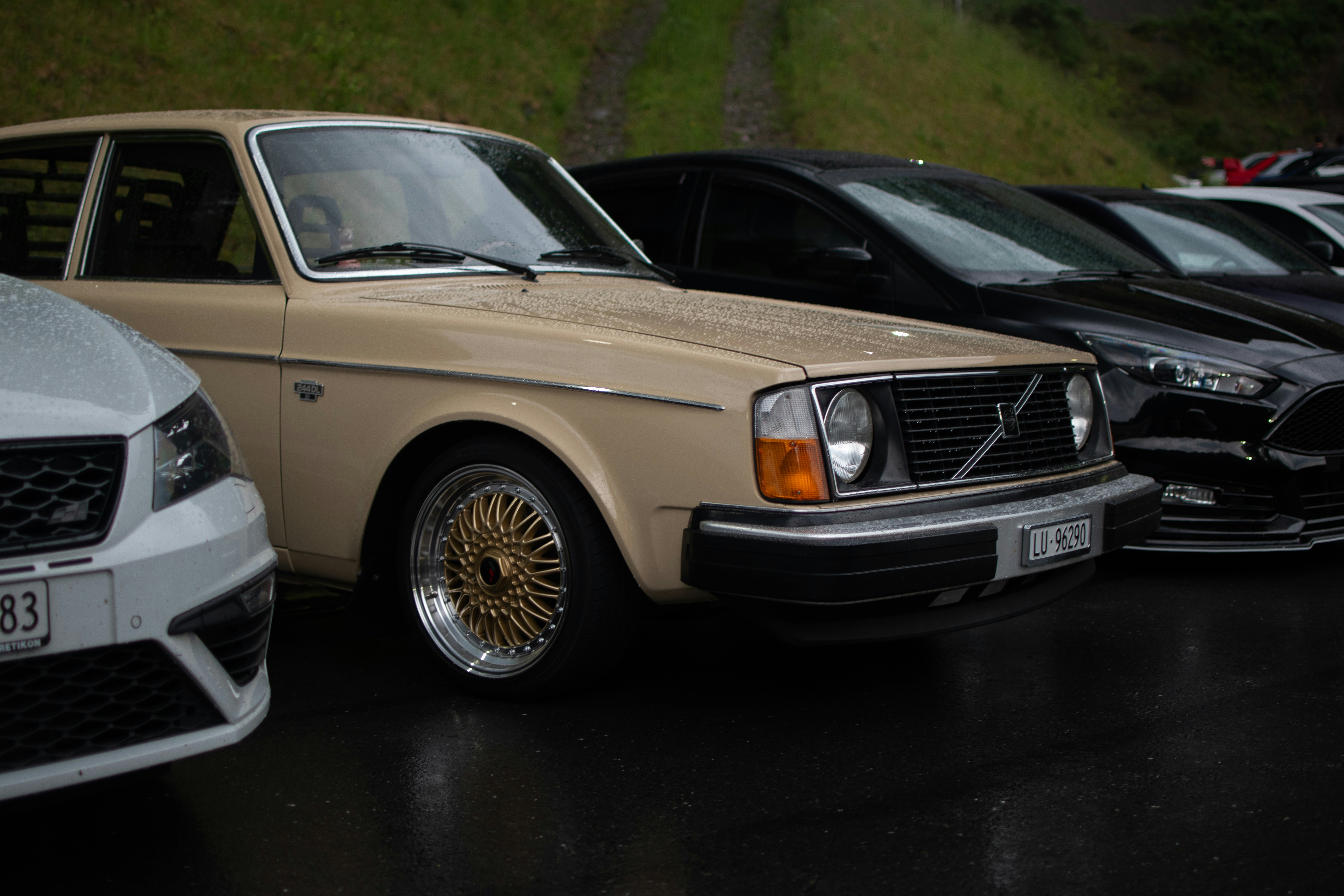 A group of cars parked next to each other in a parking lot