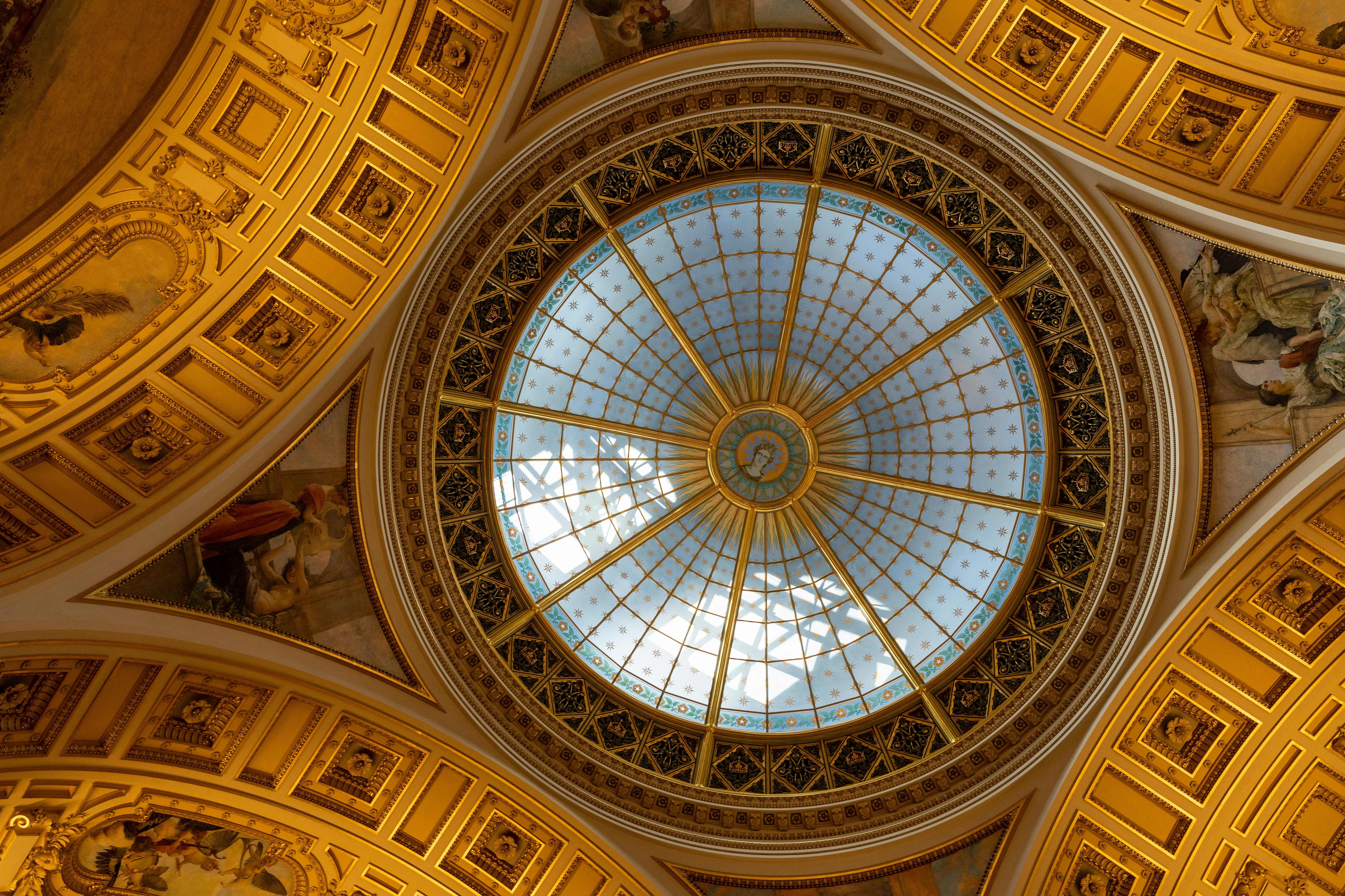 The ceiling of a building with a domed glass dome