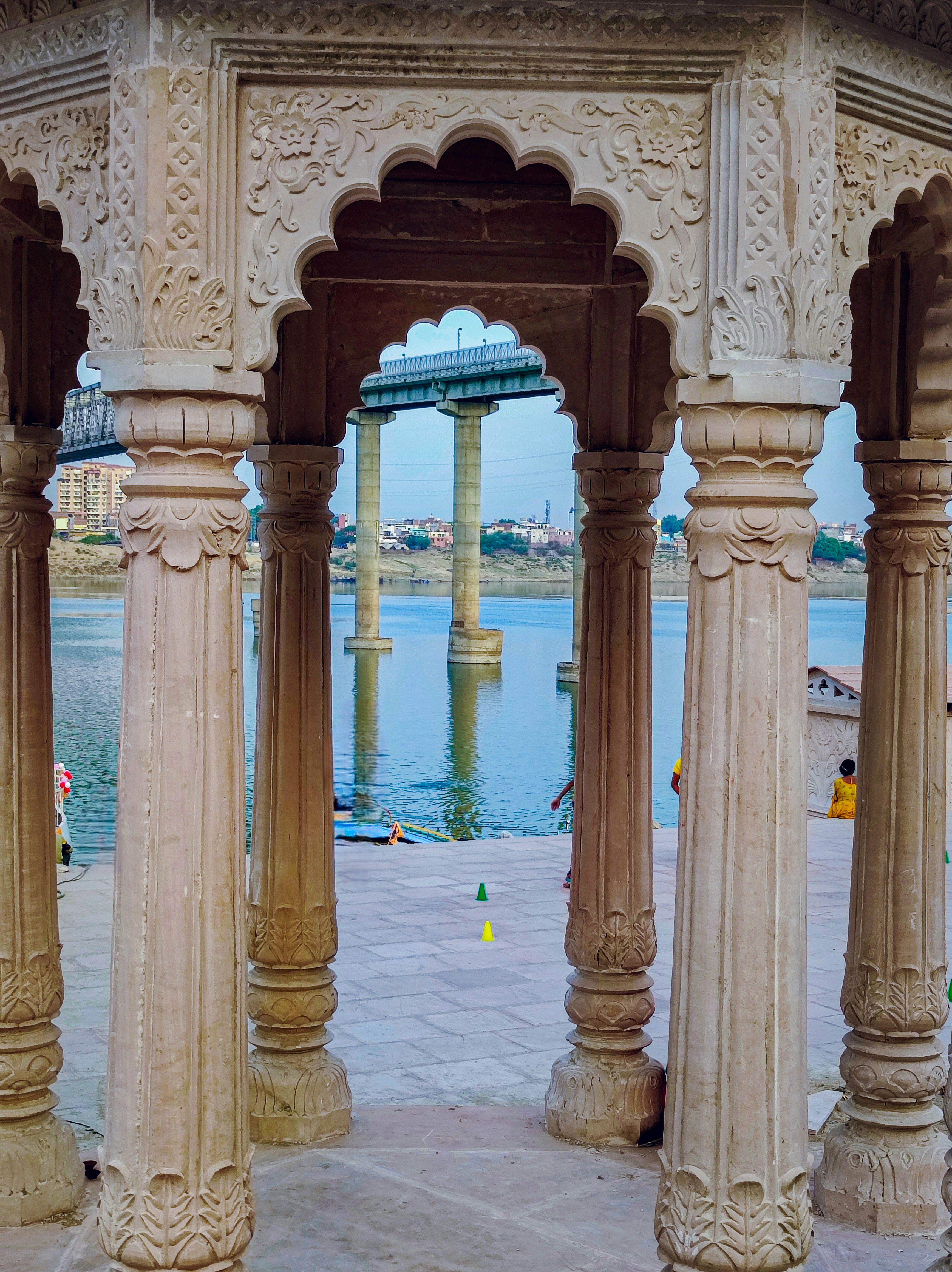 A view of a large body of water through some pillars