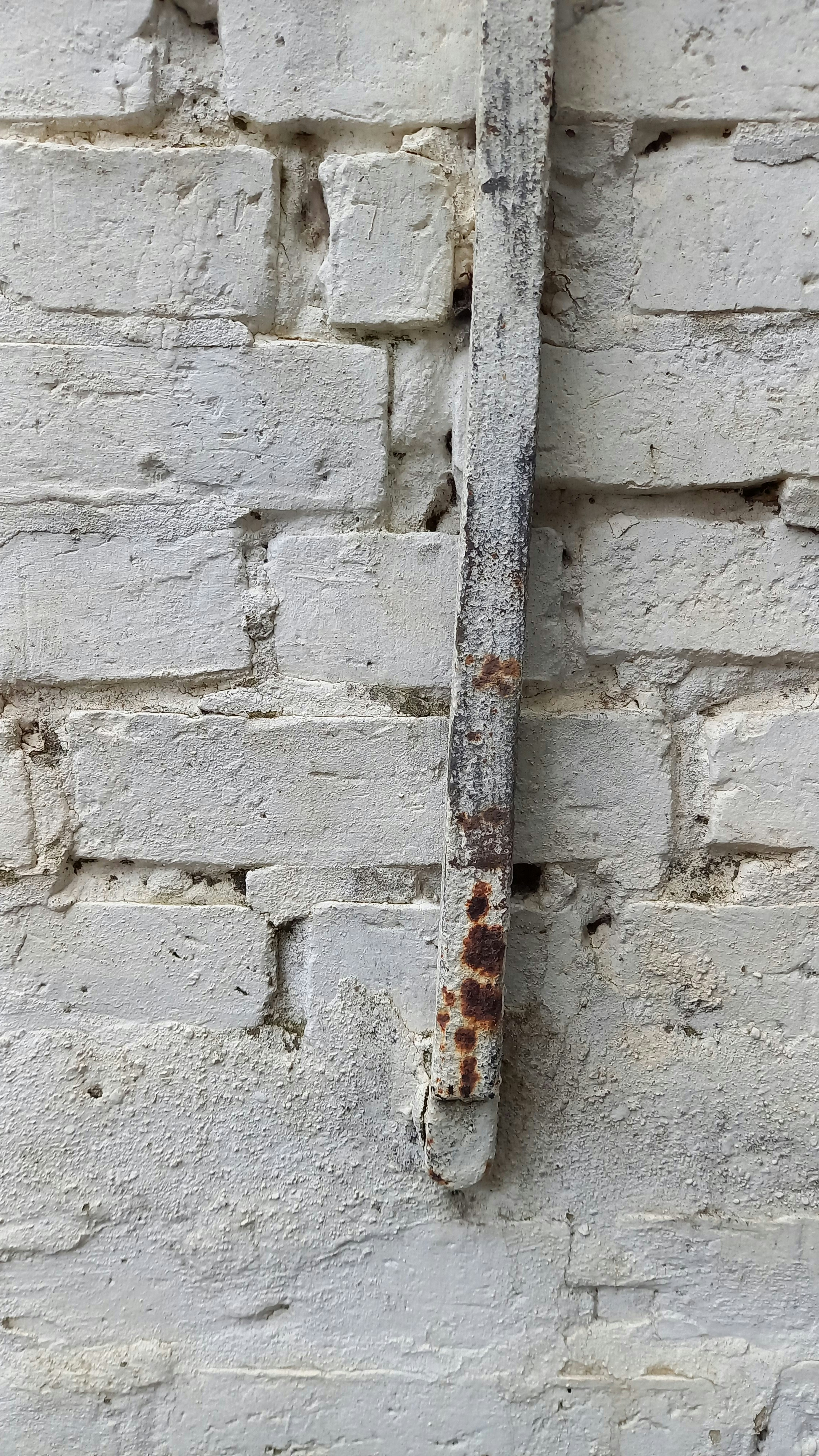 Drilling into concrete wall with a hammer drill