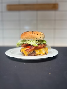 A cheeseburger with lettuce and tomato on a plate