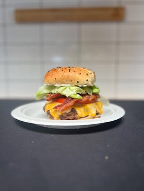 A cheeseburger with lettuce and tomato on a plate