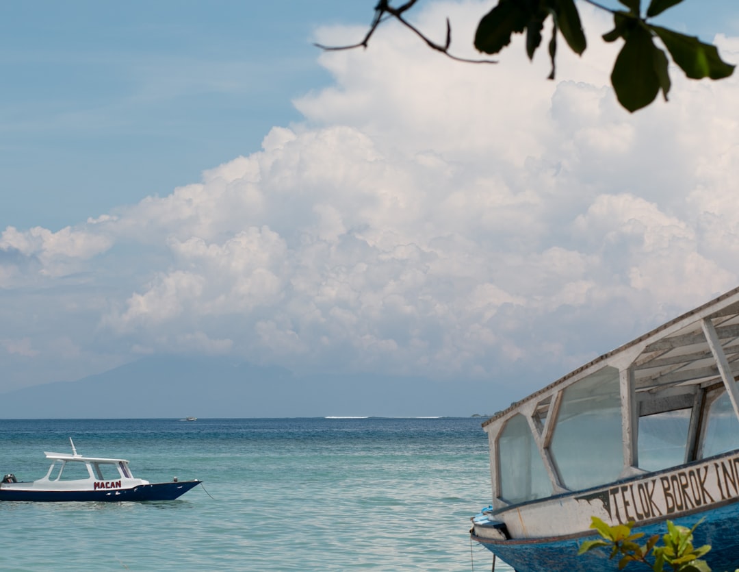 A boat floating on top of a large body of water,