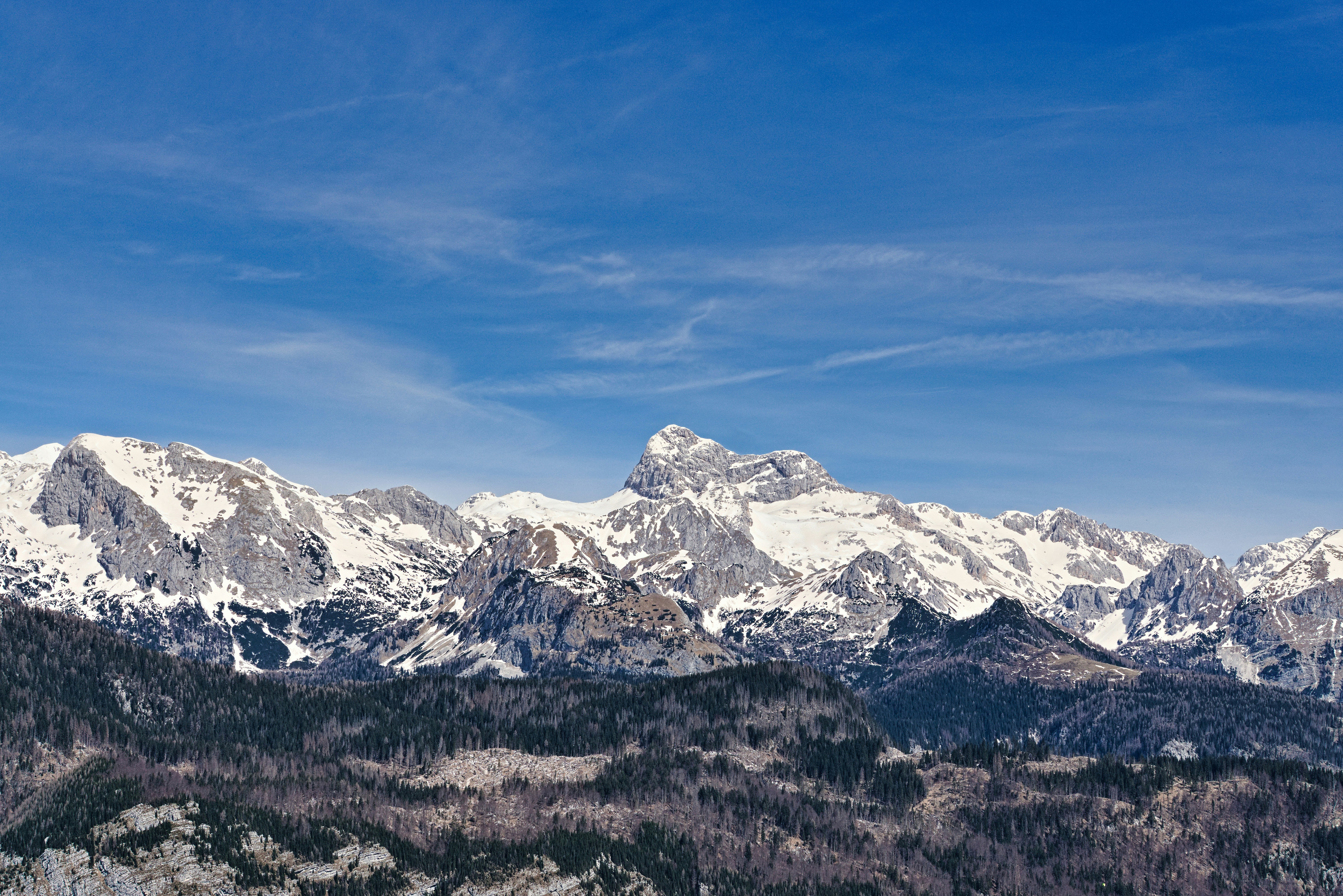 A view of a mountain range with snow on it
