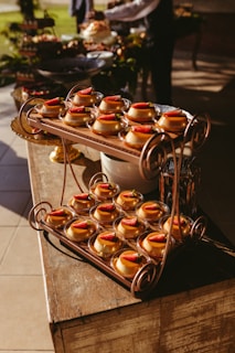 A table topped with lots of donuts on top of a wooden table