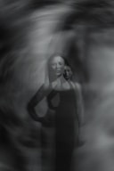 A black and white photo of a woman in a dress