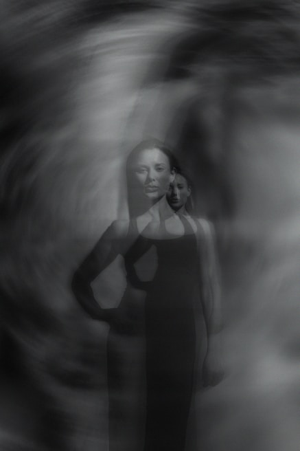 A black and white photo of a woman in a dress