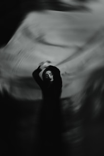 A blurry photo of a person holding a cell phone