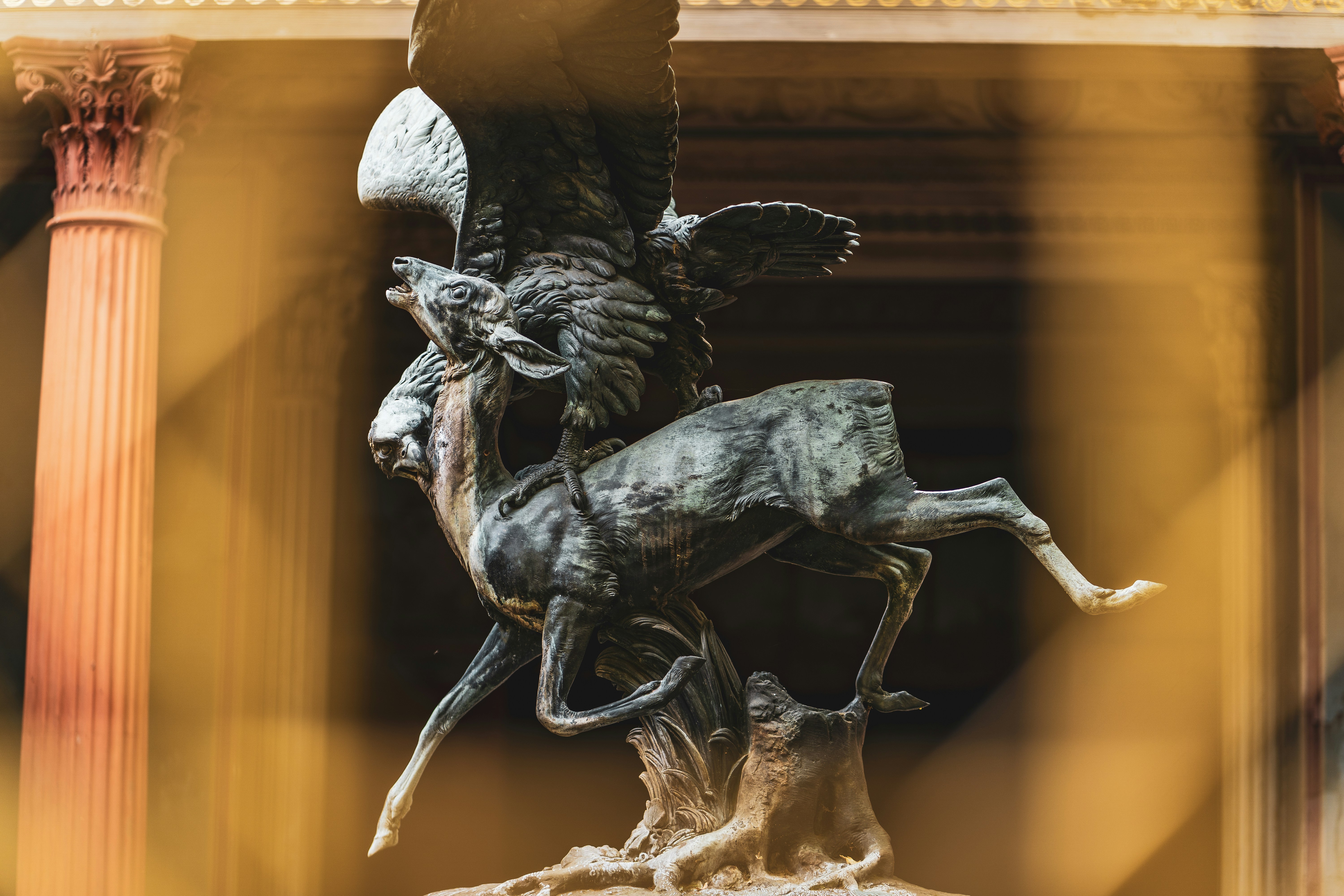 A statue of a man riding a horse in front of a building