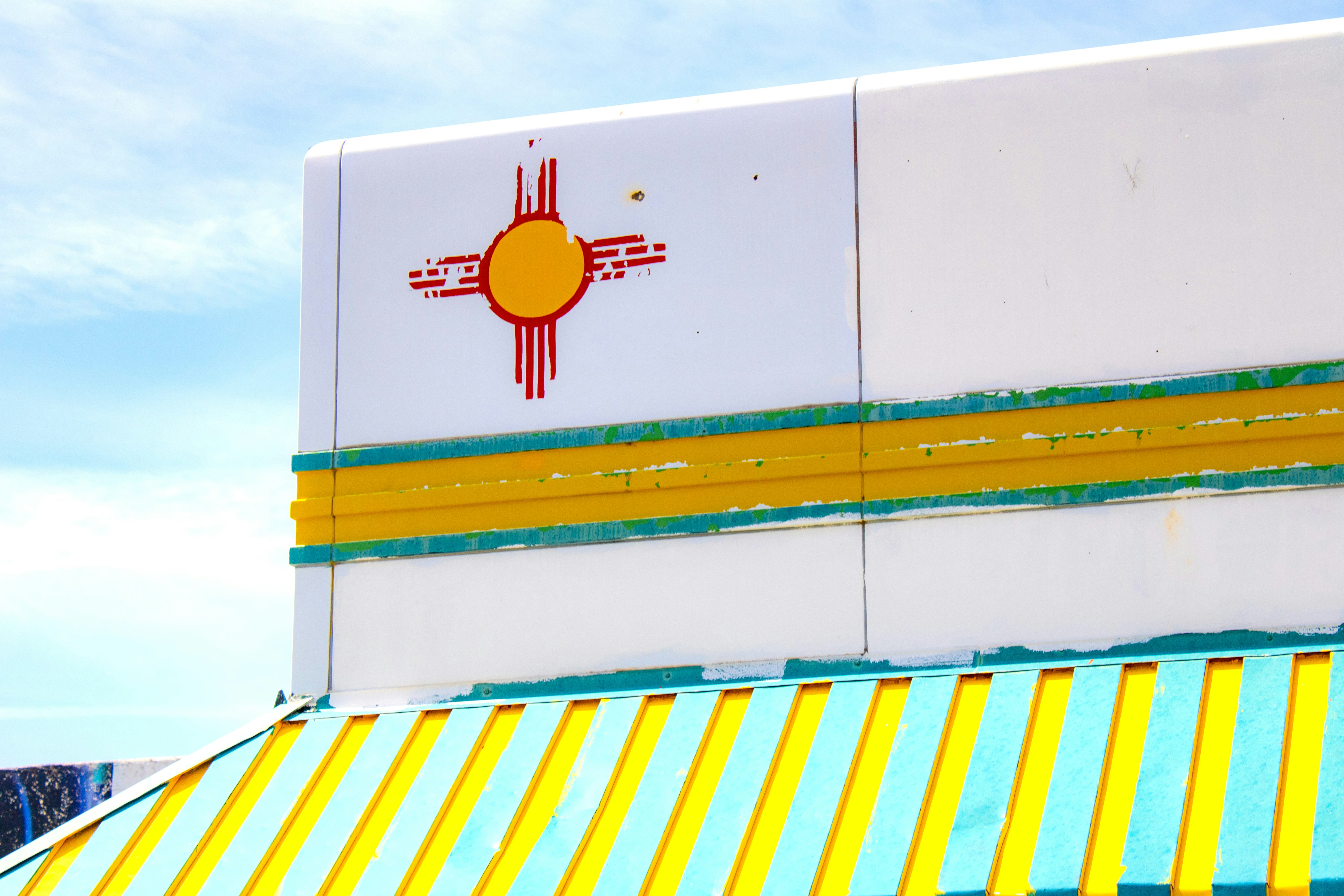 A yellow and blue striped awning on a building
