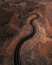 An aerial view of a winding road in the desert