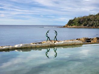 A large body of water with a statue in the middle of it