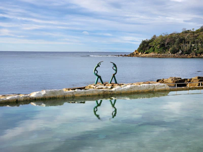 A large body of water with a statue in the middle of it