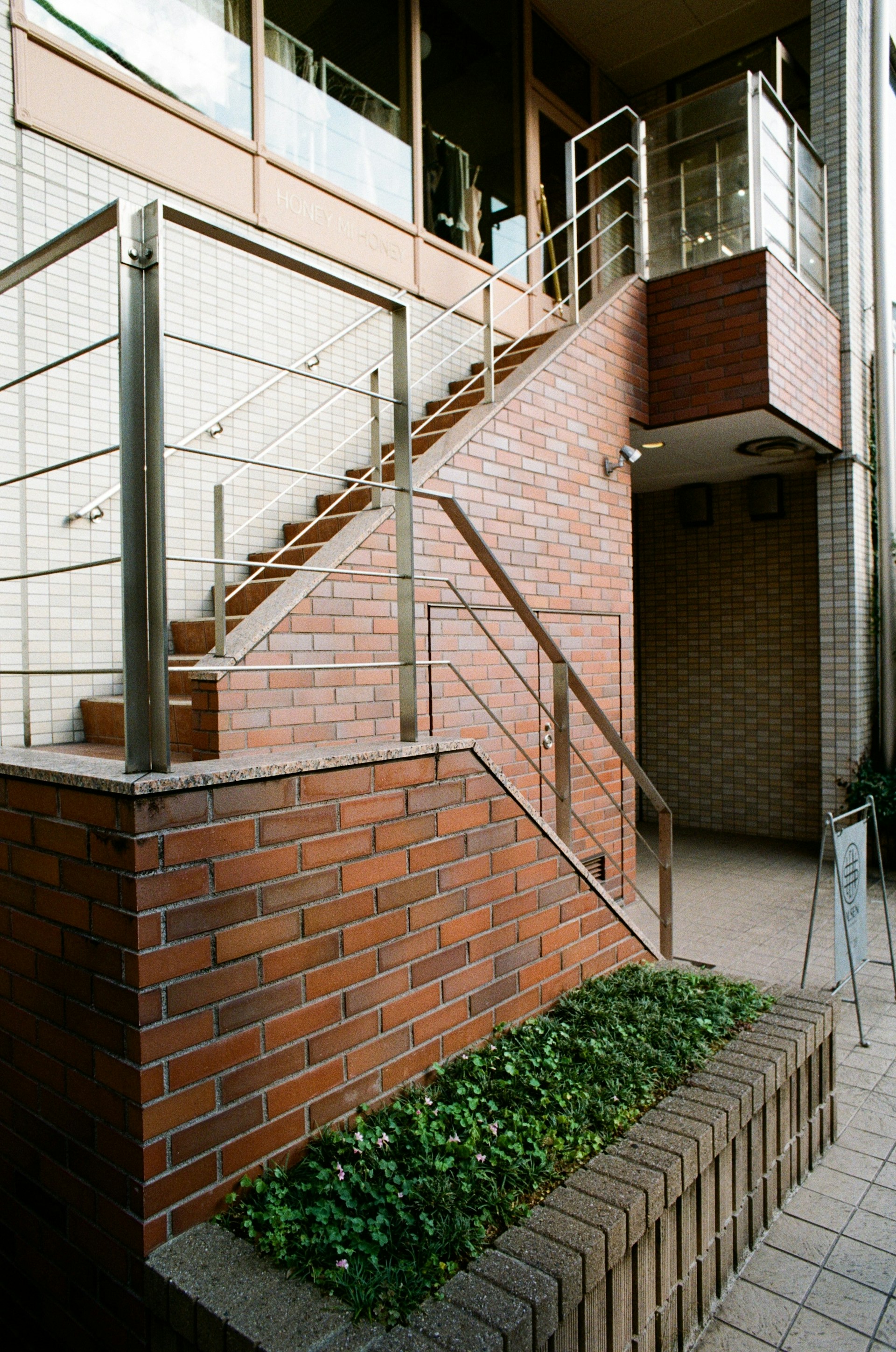 A brick building with a metal hand rail