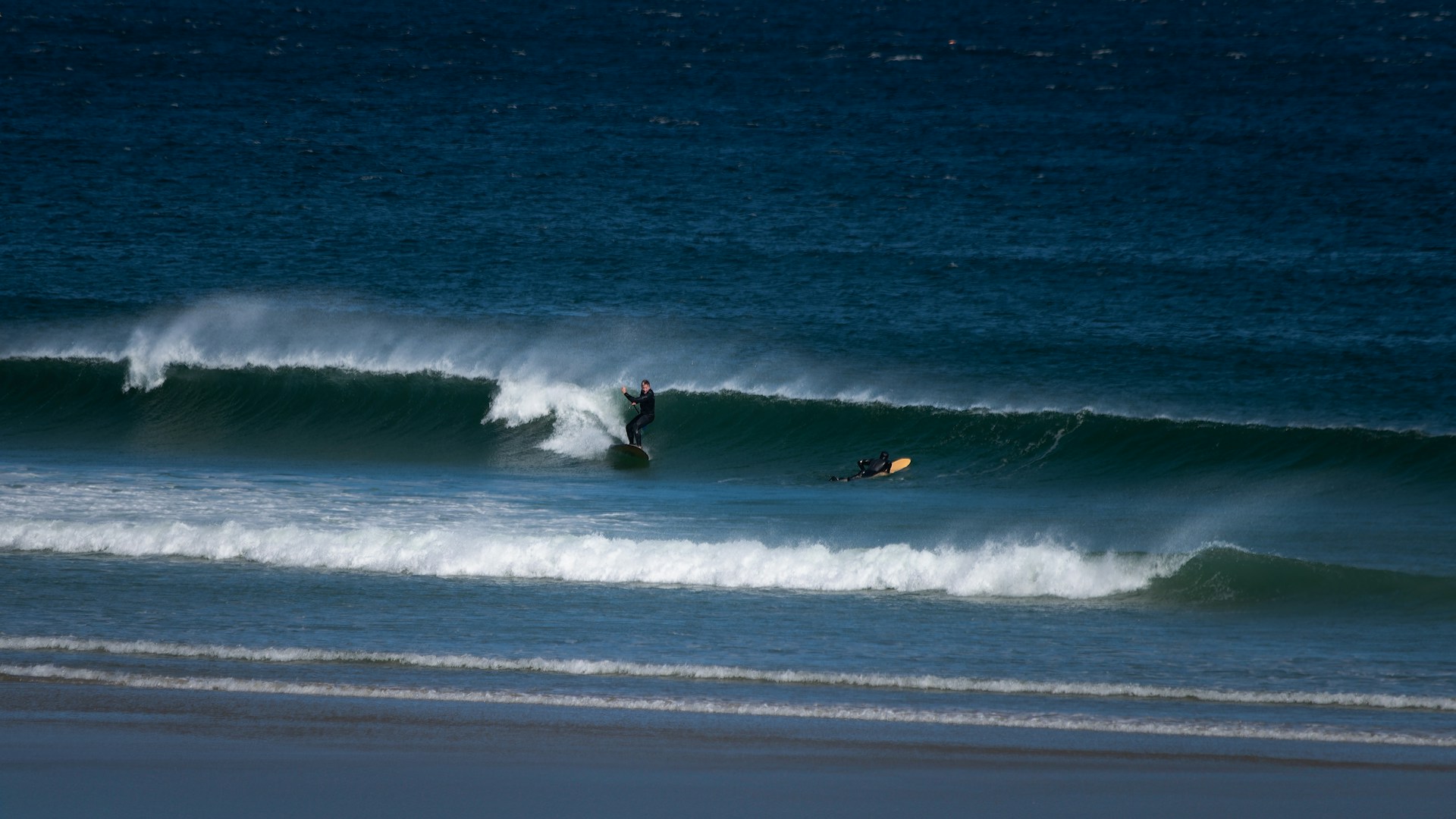A person riding a wave on top of a surfboard