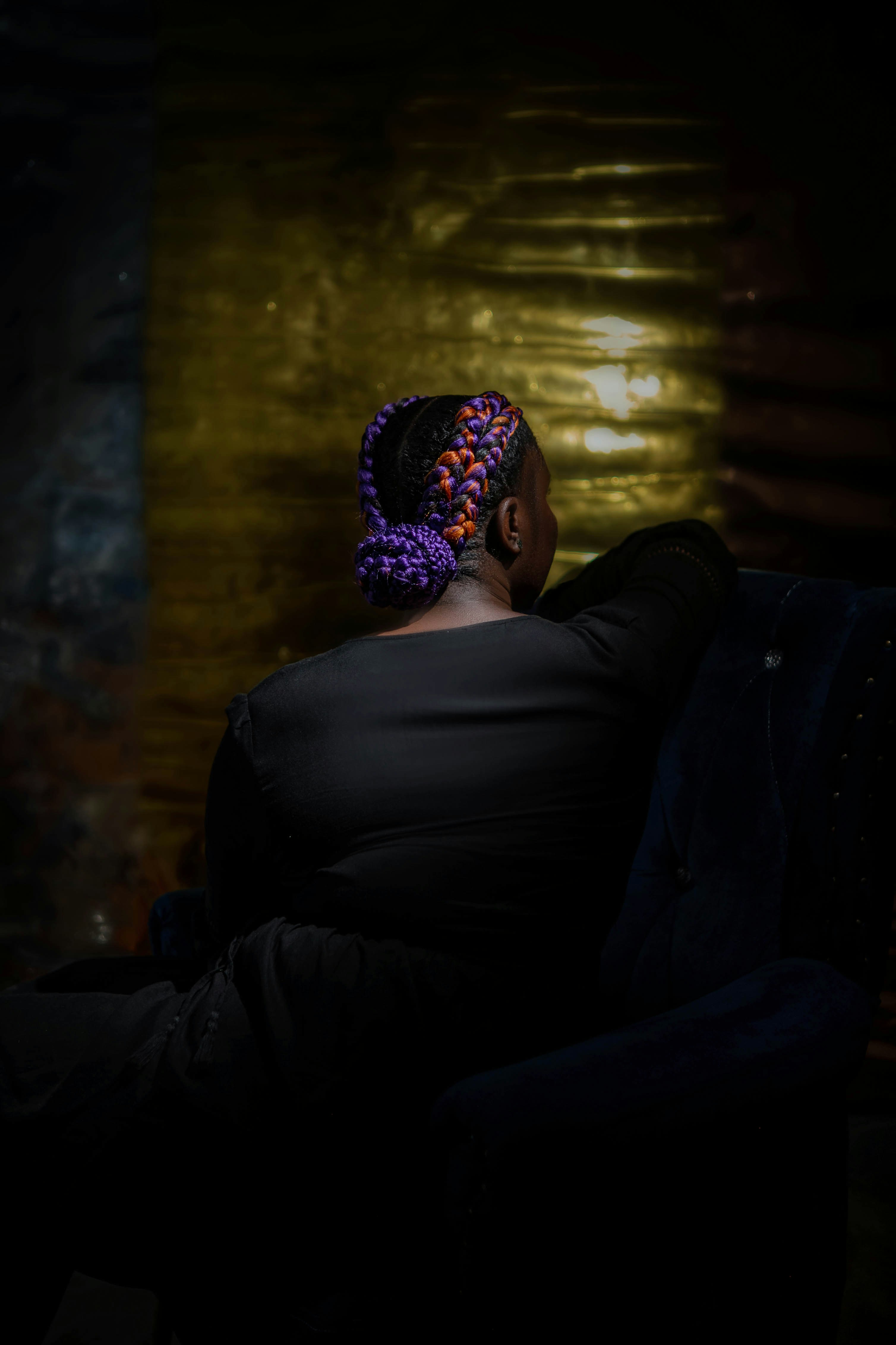 A woman sitting in a chair in a dark room