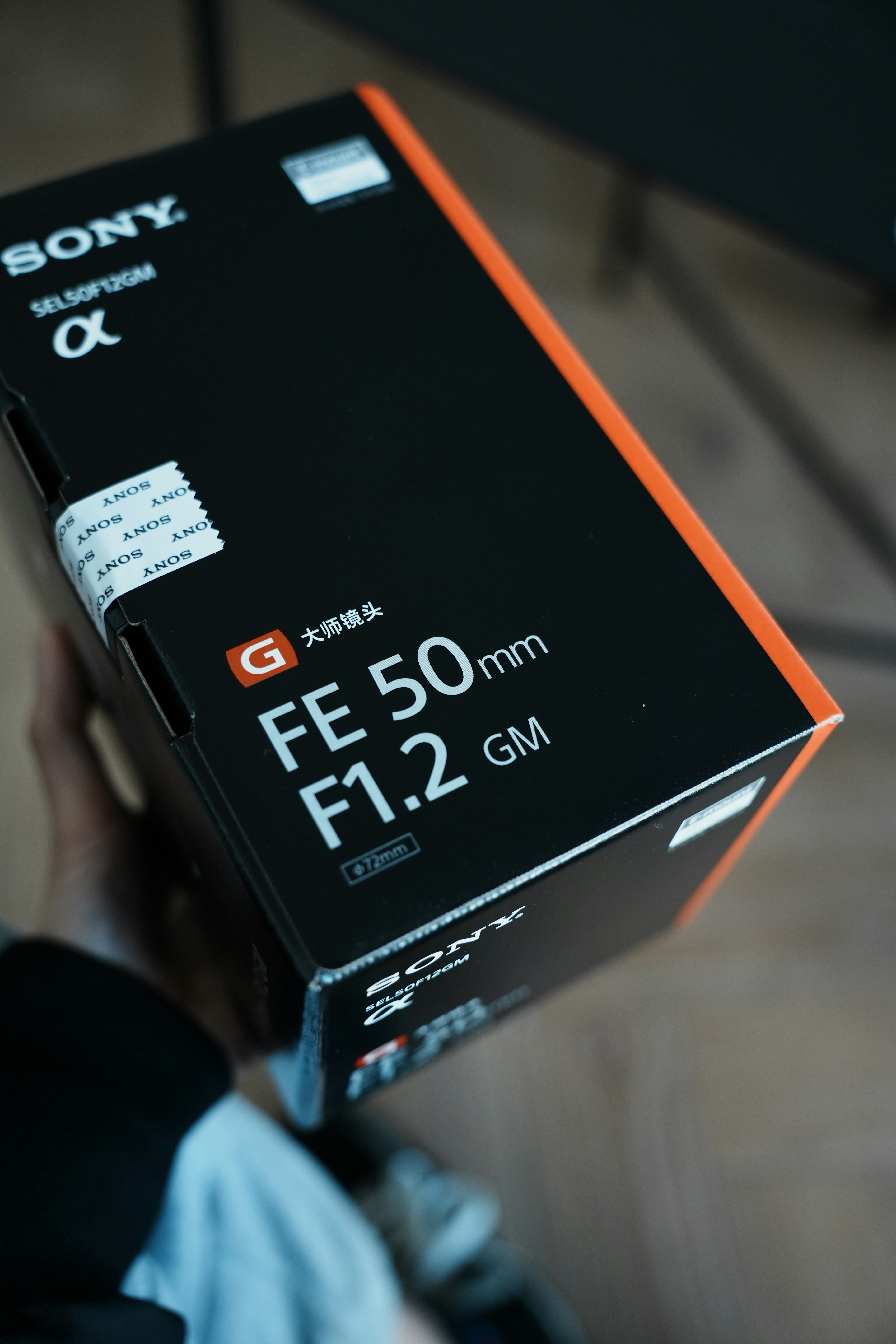 A person holding a box with a camera inside of it