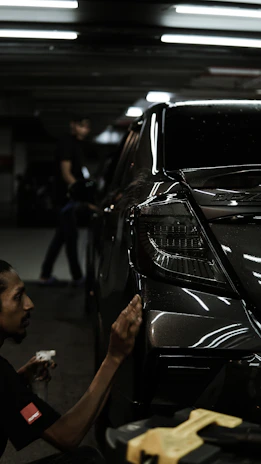 A man working on a car in a garage