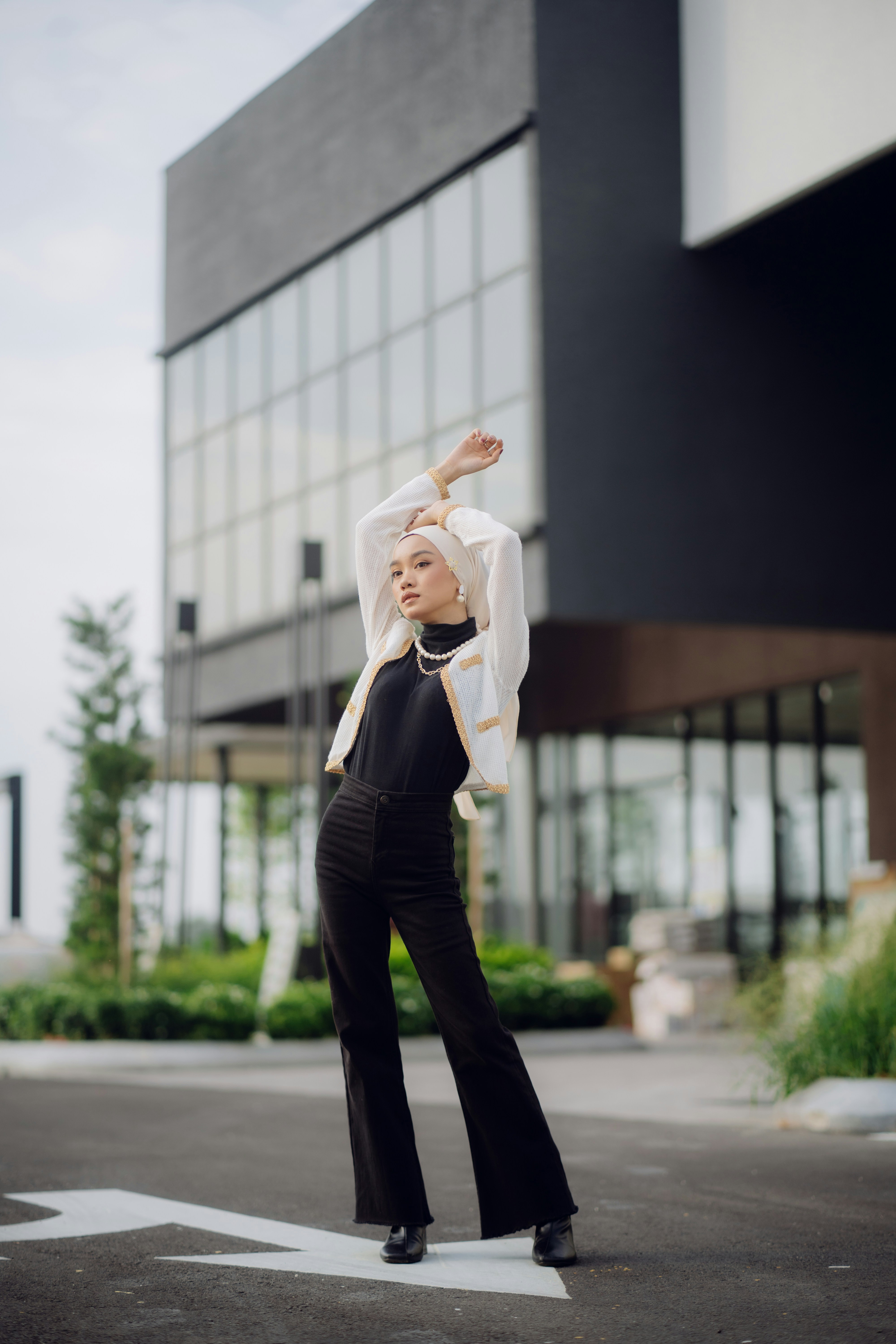 A woman in a white shirt and black pants