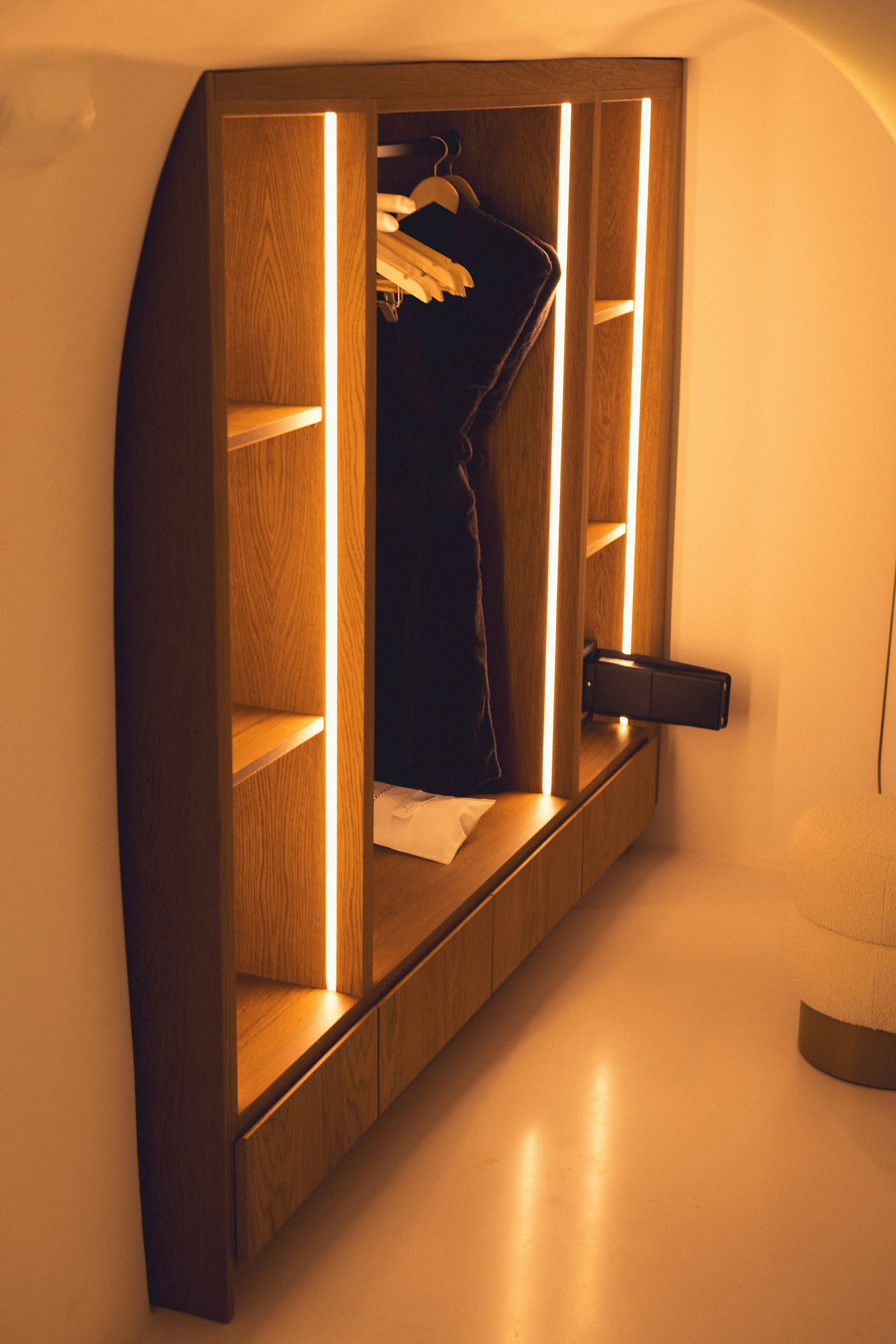 A closet with a mirror and a coat rack