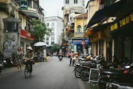 A group of people riding bikes down a street