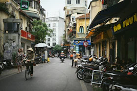 A group of people riding bikes down a street