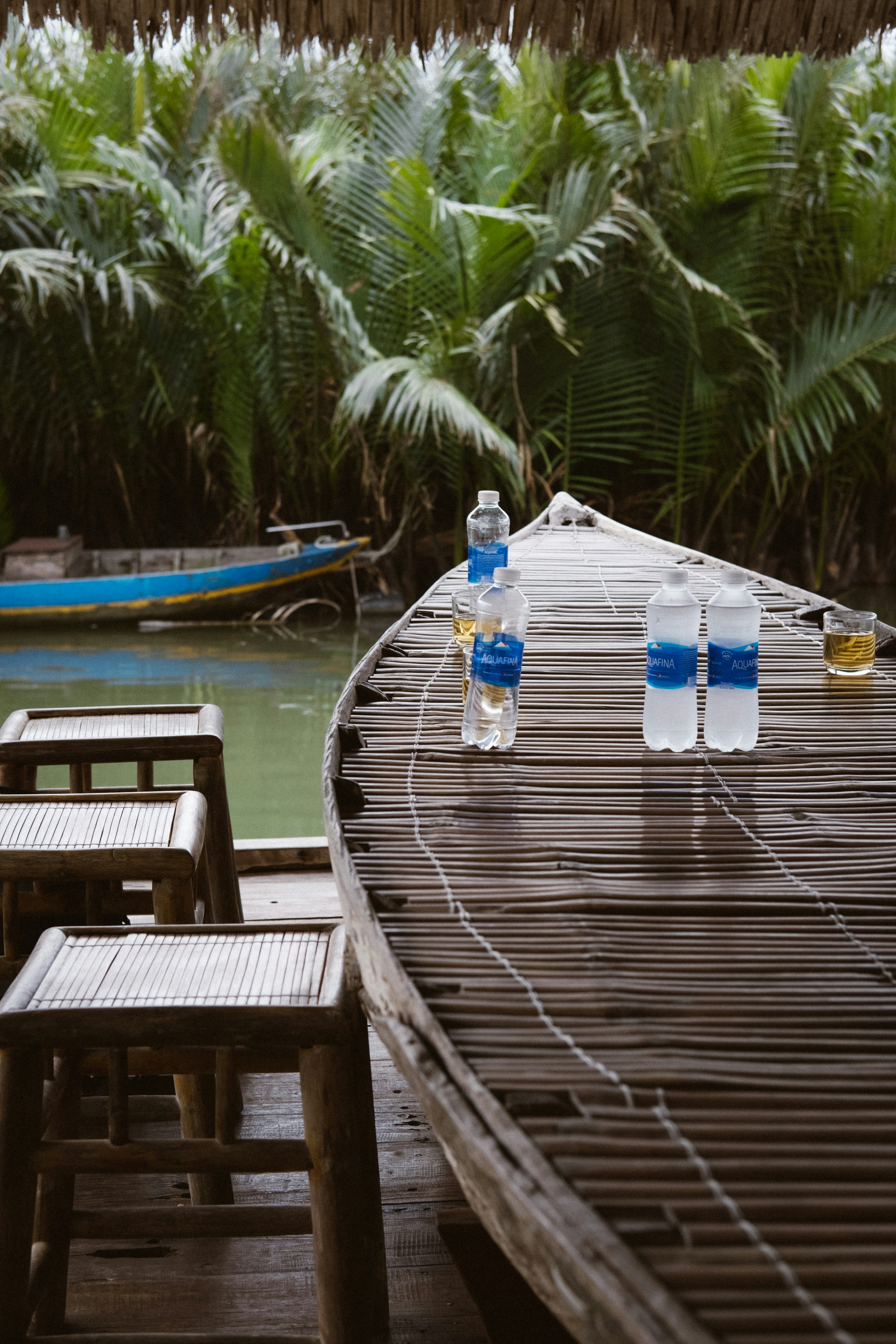 A wooden table sitting next to a body of water