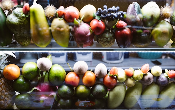 A display case filled with lots of different types of fruit