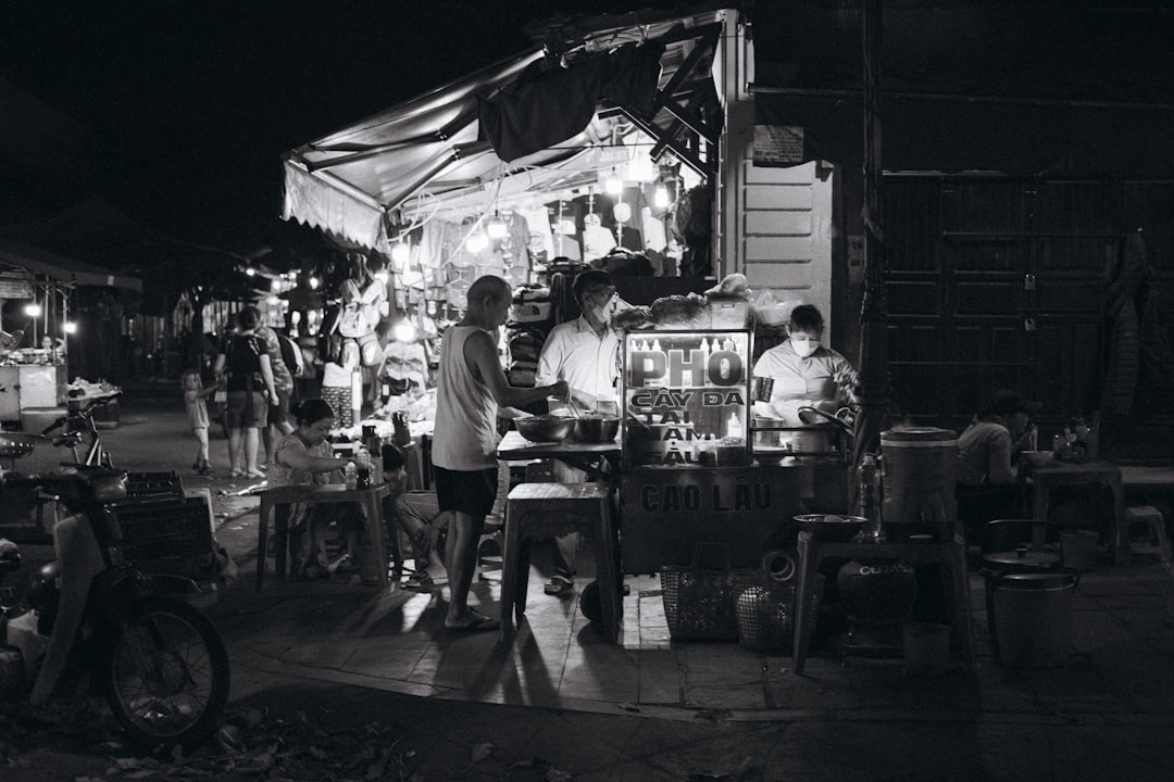 A black and white photo of a night market,