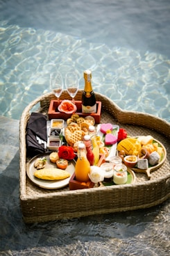 A heart shaped tray filled with food next to a pool