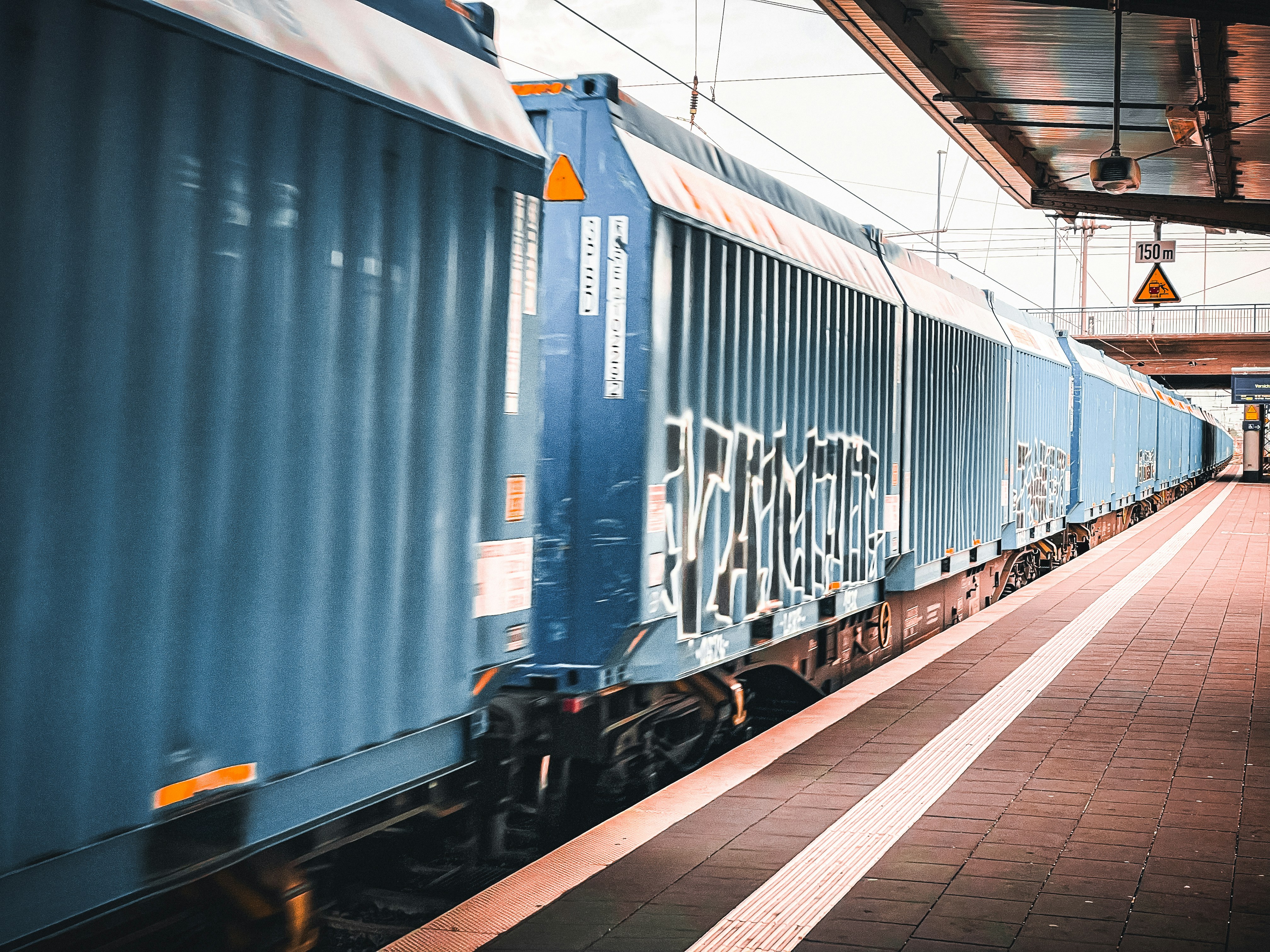 A train pulling into a train station next to a platform