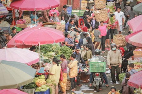 A large group of people walking around a market