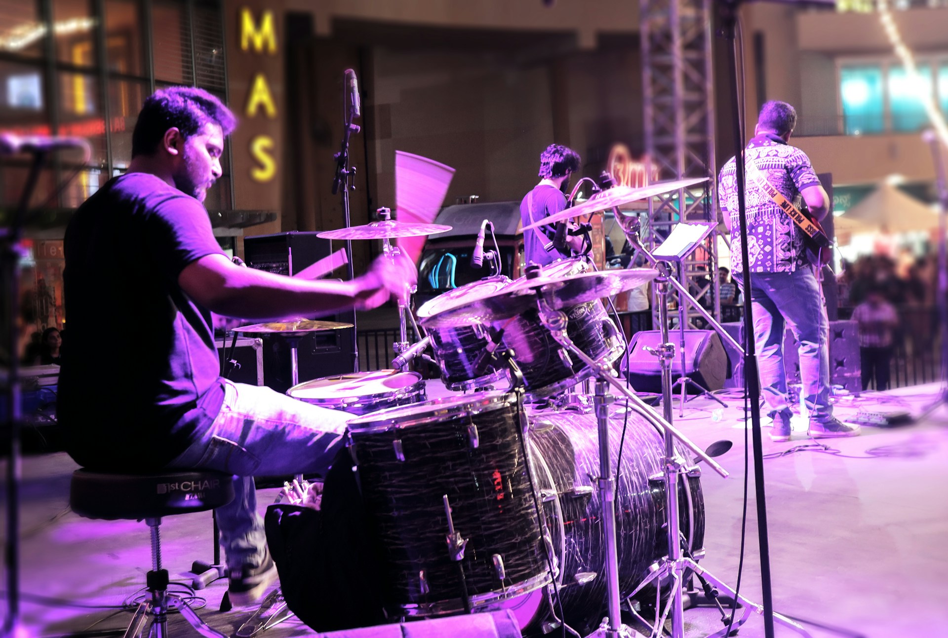 A man sitting on top of a drum set