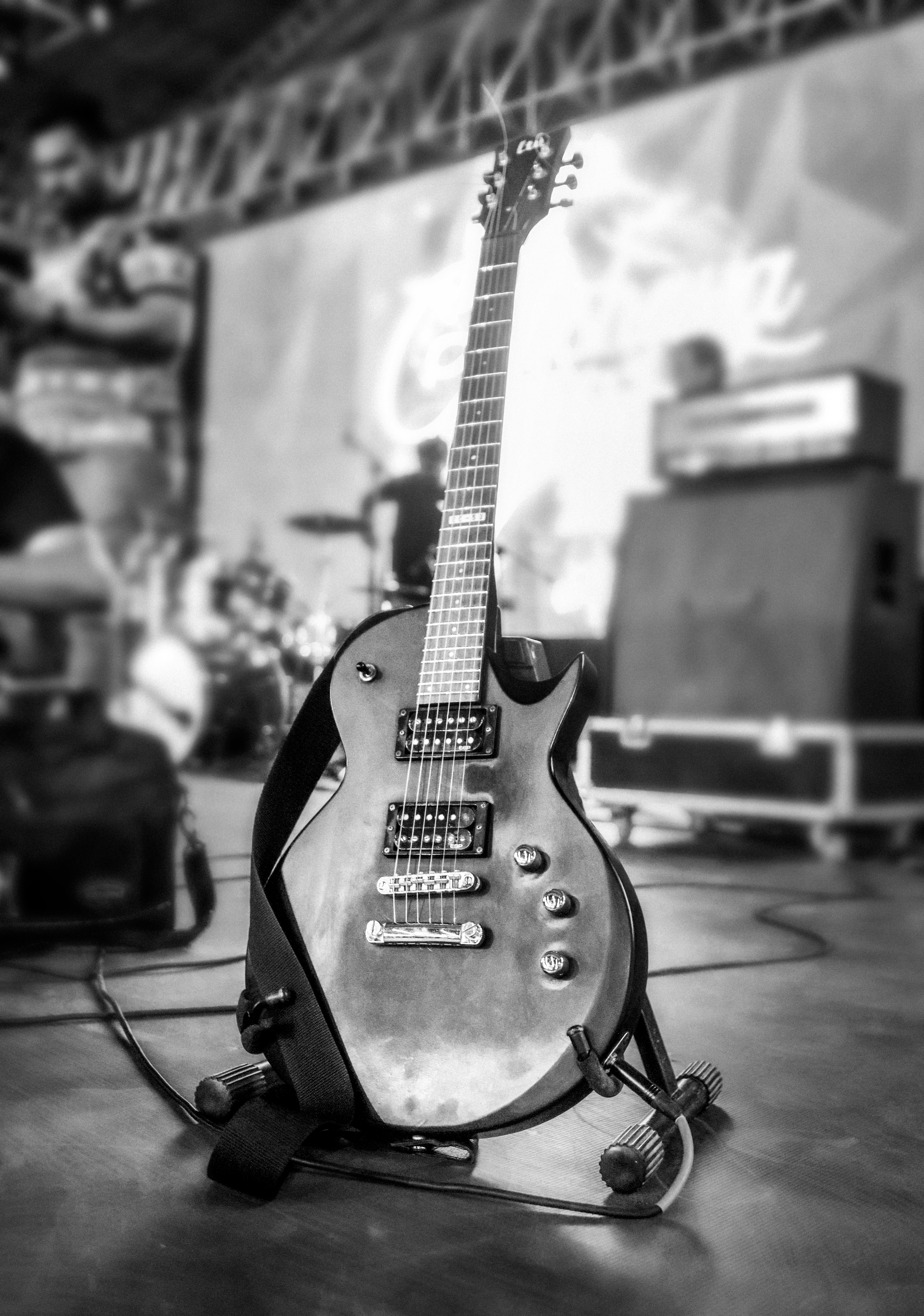 A guitar sitting on top of a wooden table