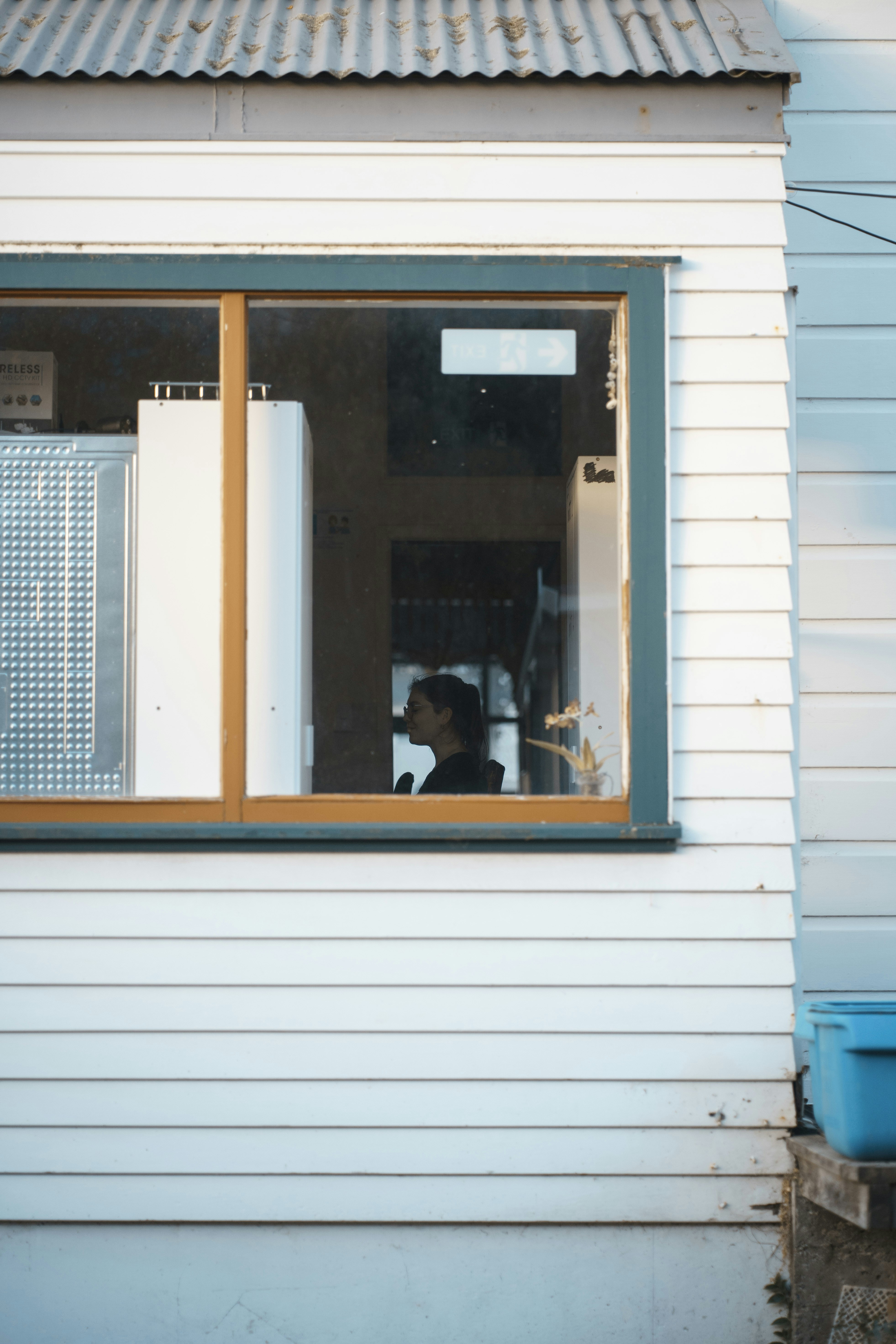 A man looking out a window of a house