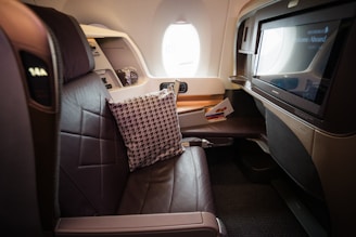 A view of the inside of an airplane with a flat screen TV