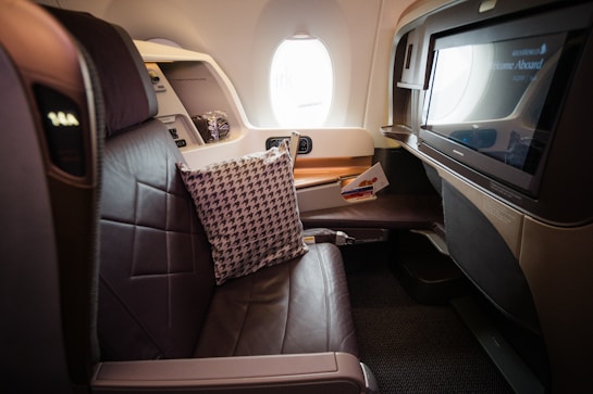 A view of the inside of an airplane with a flat screen TV